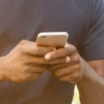 Close-up of a person holding and using a smartphone