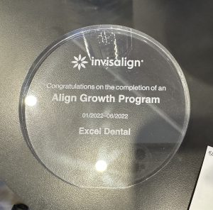 Round clear Invisalign Align Growth Program award plaque engraved with Excel Dental.