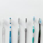 Seven toothbrushes lined up against a white background with copy space above.