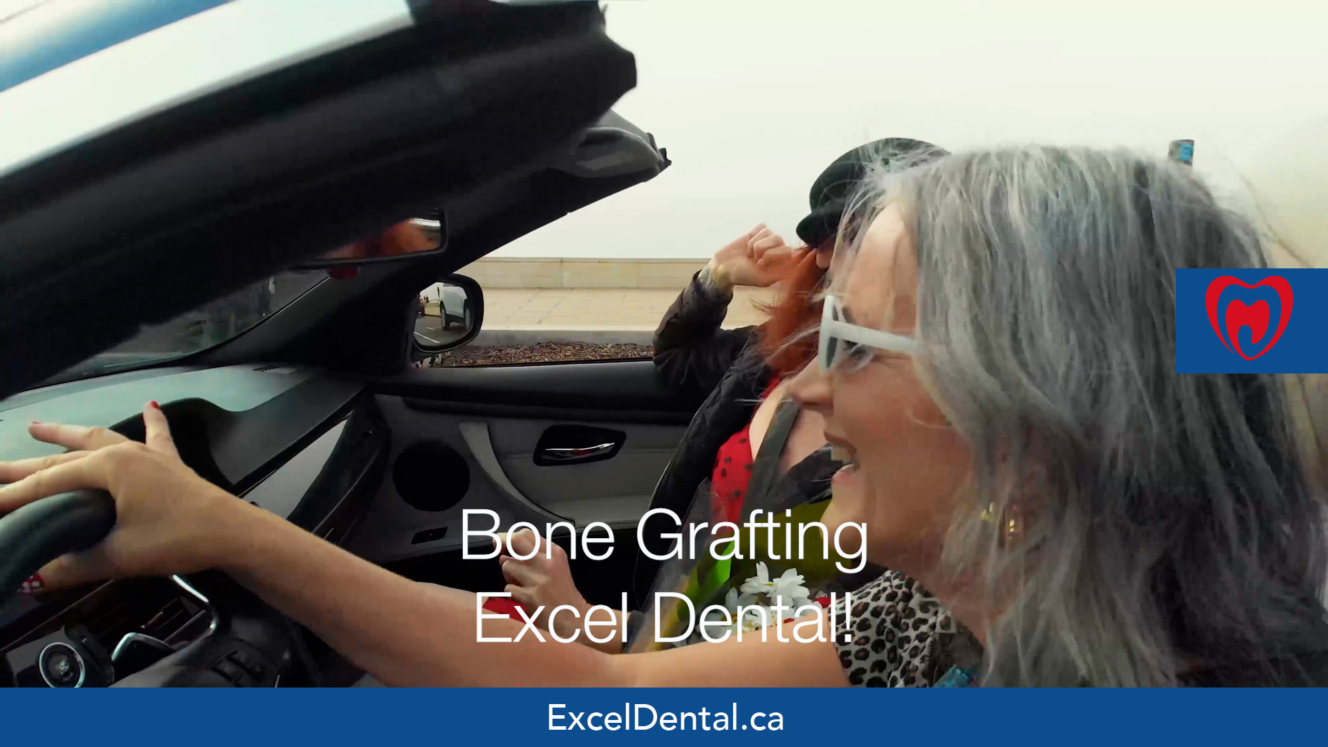 Older woman smiling in a convertible with another passenger, overlaid with Bone Grafting Excel Dental text.