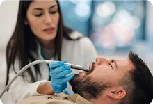 Dentist providing an oral surgery procedure